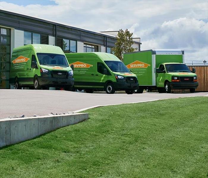 SERVPRO® Team Vans Stocked Ready To Assist In Front Of Warehouse