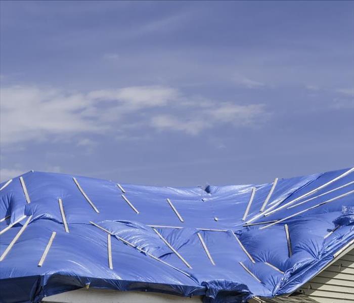 blue tarps covering a roof